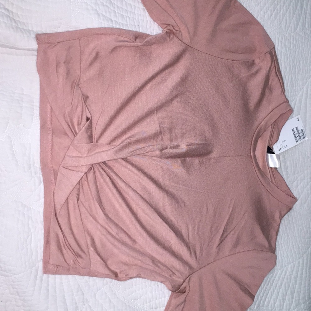 Unused H&M pink medium shirt with twist at bottom.